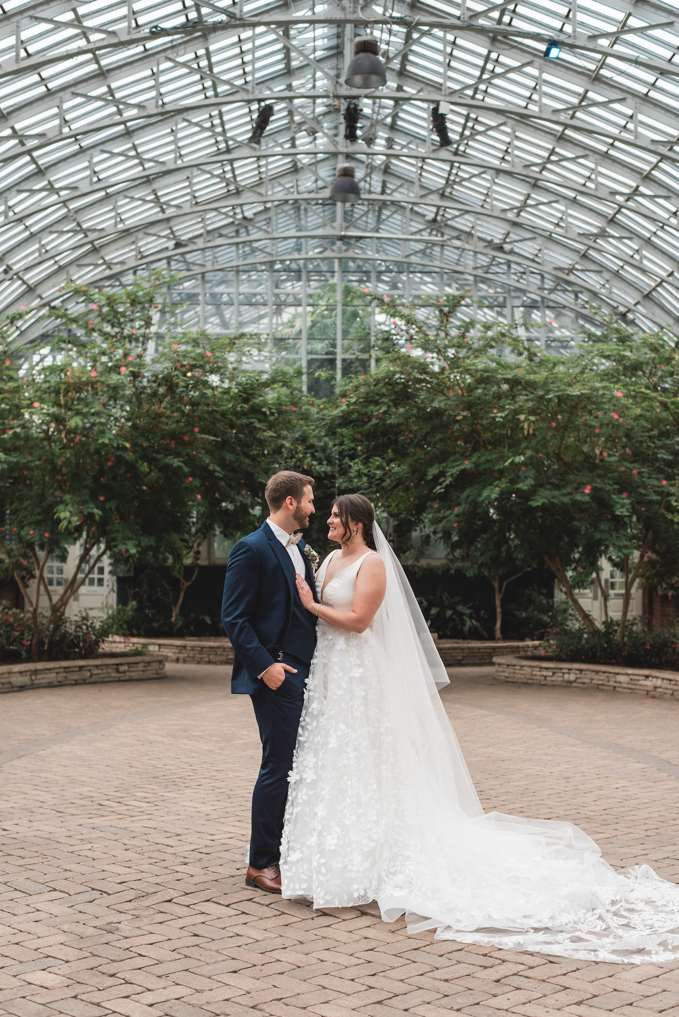 Bride and groom smiling at each other in Garfield Park Conservatory