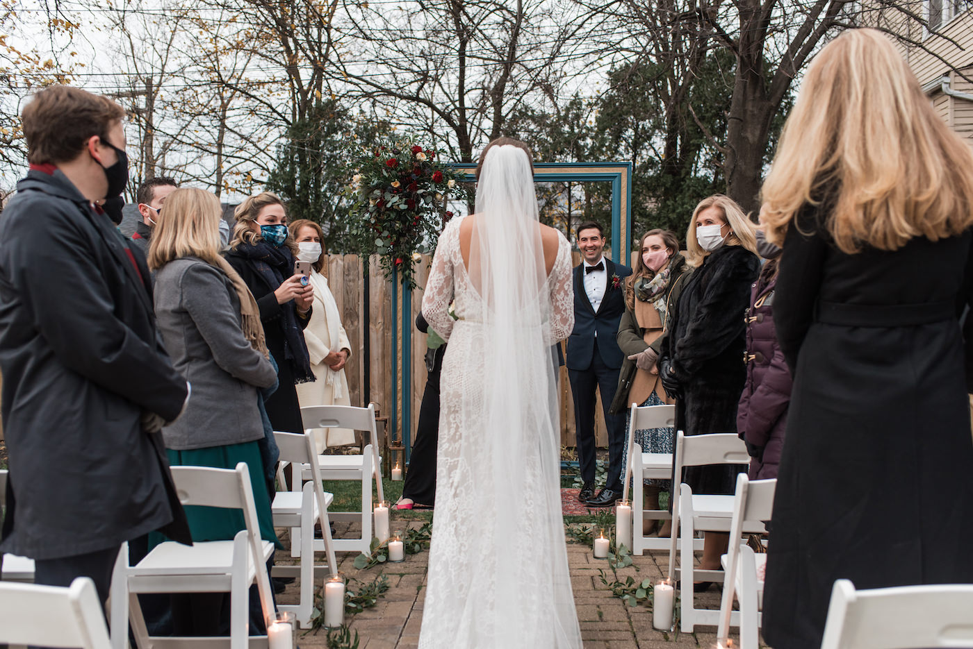 Bride walks down the aisle at a backyard ceremony