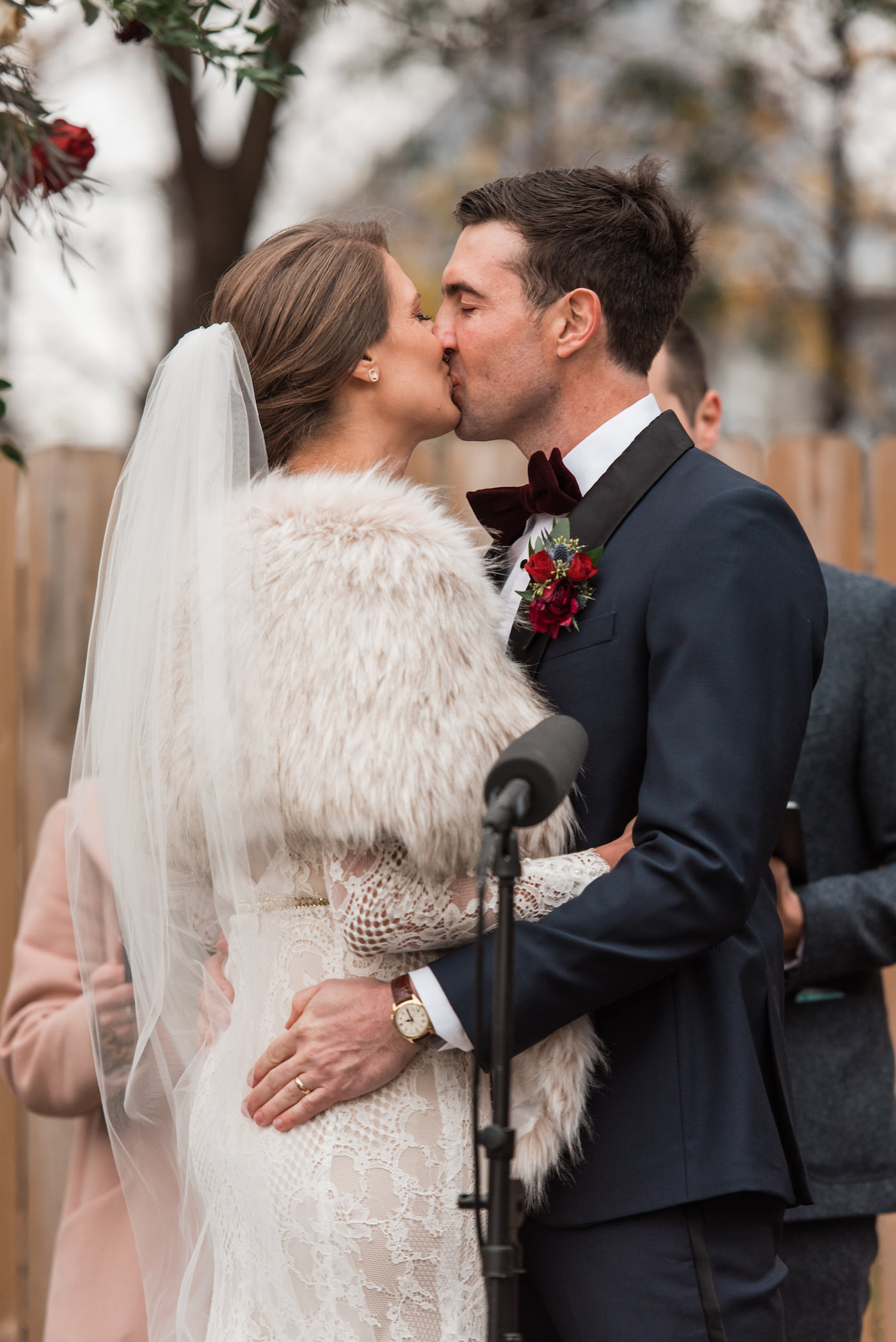 Bride and Groom share first kiss during their outdoor winter wedding