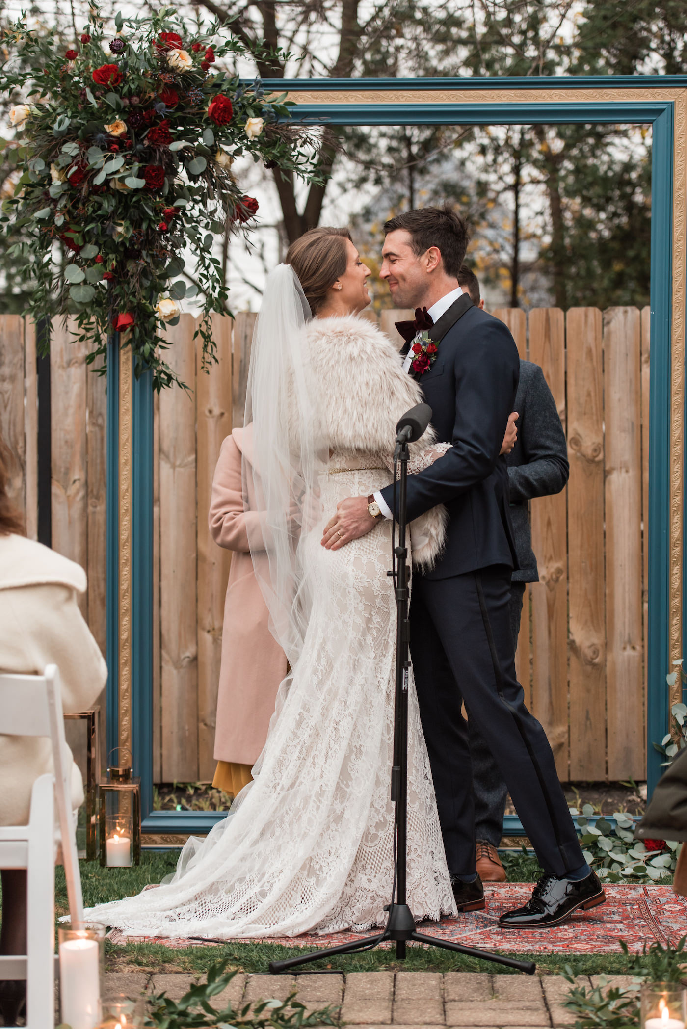 Bride and groom smiling at each other after their first kiss