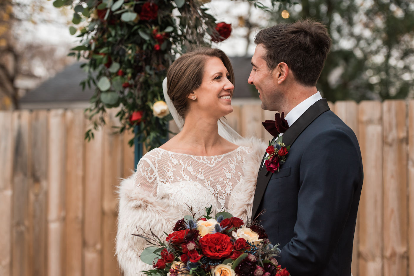 Newlyweds smiling at each other after their ceremony