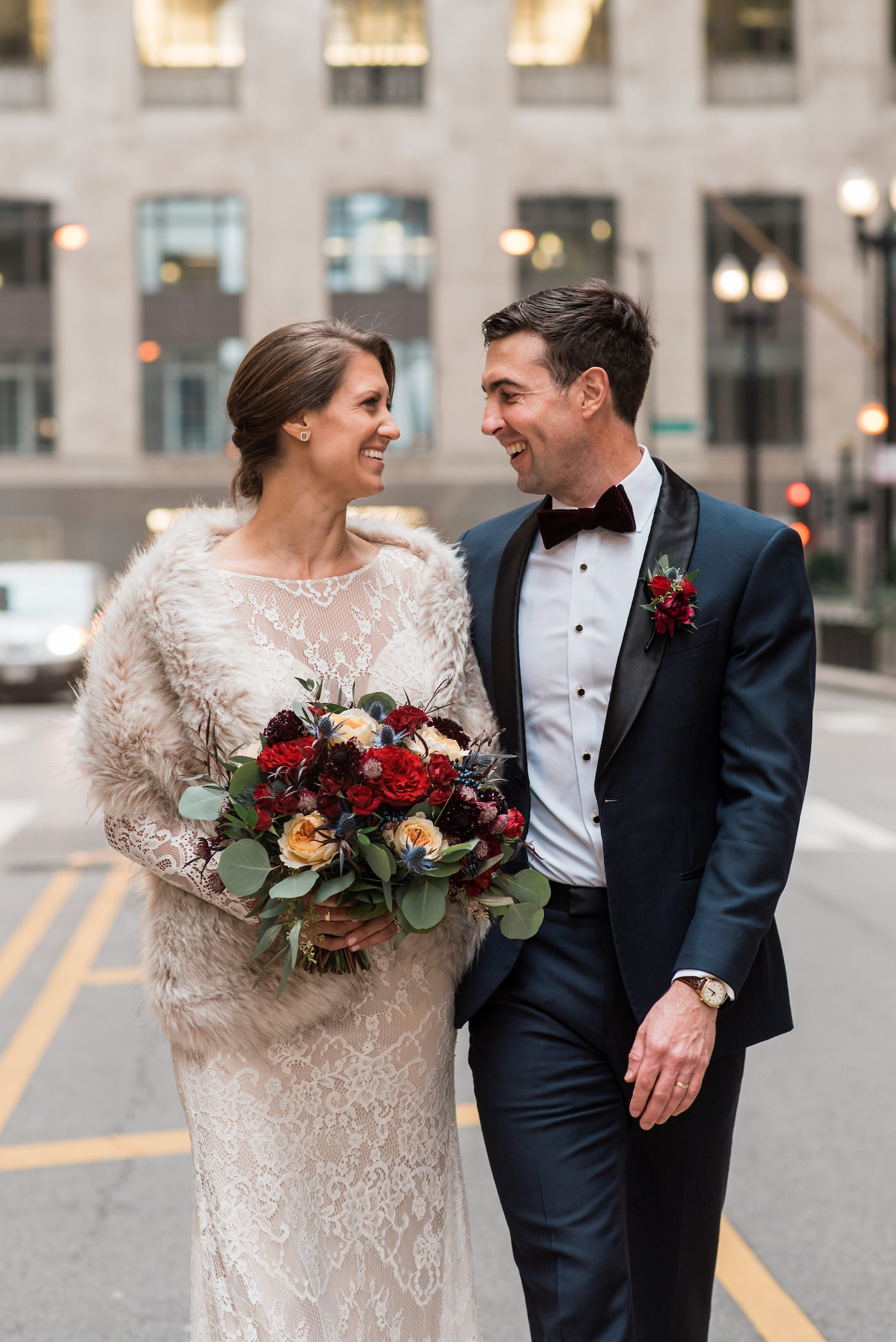 Newlyweds smiling at each other in front of Chicago's Board of Trade building